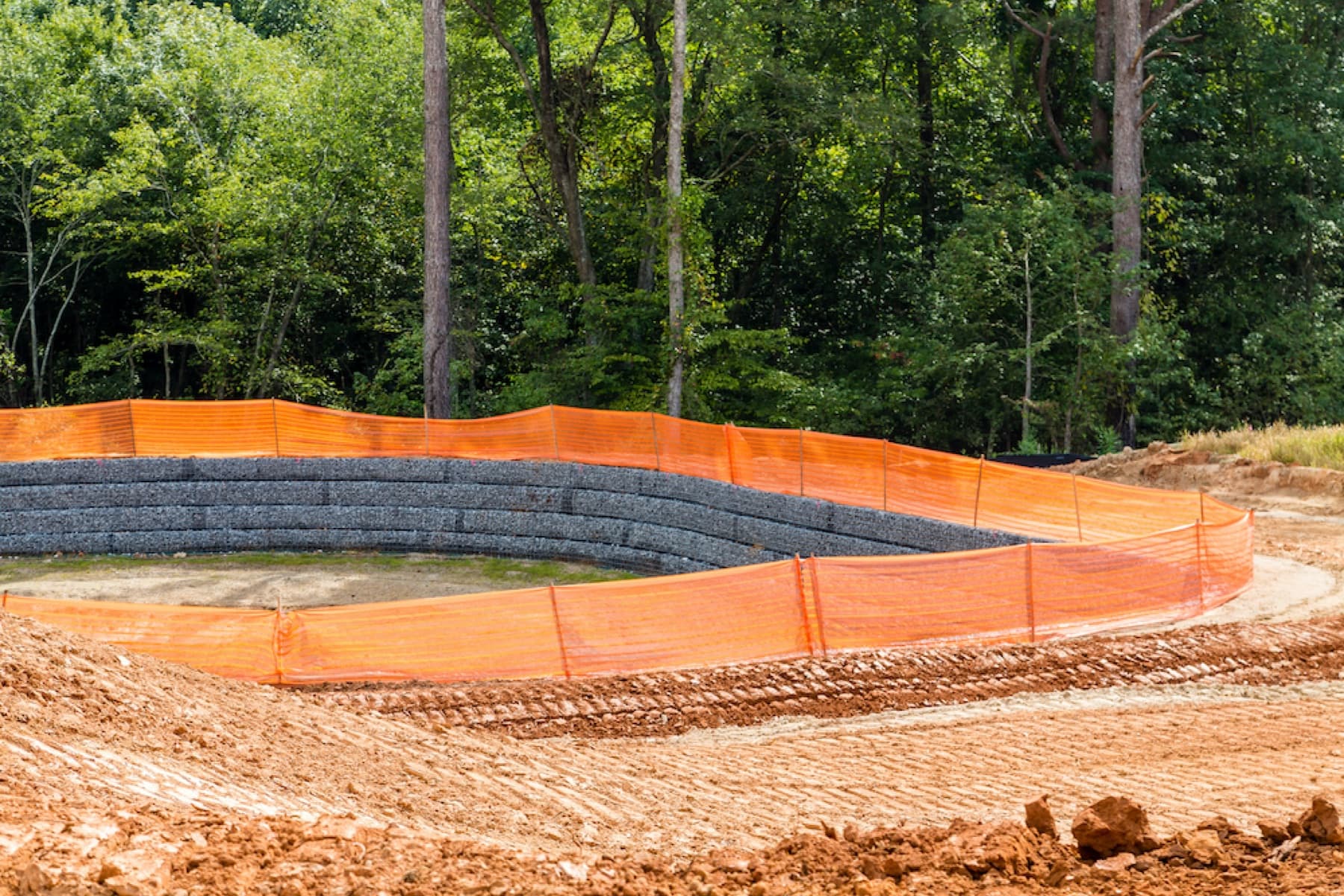 Prepared JL Landworx site with erosion-control barriers and compacted aggregate